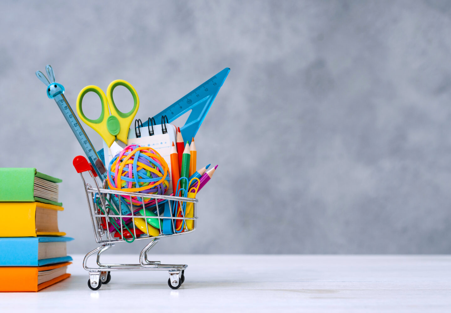 FunJoyLand colorful-school-supplies-shopping-basket-gray-background-with-copy-text-space-stack-books-with-colorful-covers-concept-returning-school-new-academic-year-1440x1000 The ultimate guide to choosing your kids' stationery | Funjoyland 